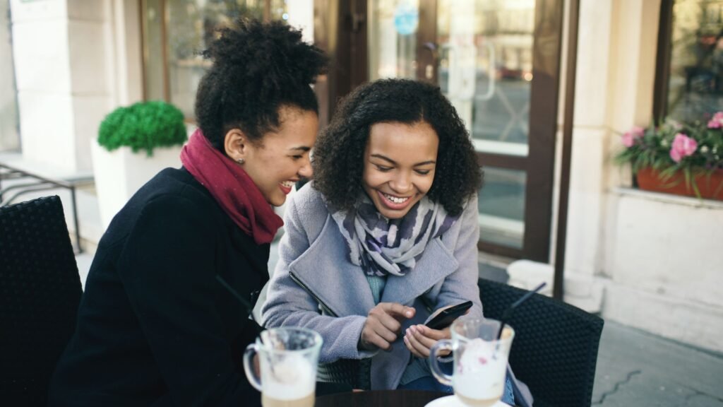 Two friends laughing together, illustrating how romantic attraction can develop through friendship.
